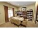 Cozy library area featuring a table with seating and built-in bookshelves filled with books and decorative items at 2771 Middlecreek Way, Cumming, GA 30041
