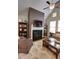 Cozy living room with a fireplace, built-in shelving, and comfortable seating, perfect for relaxing and entertaining at 2771 Middlecreek Way, Cumming, GA 30041