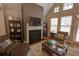Bright living room featuring vaulted ceilings, a fireplace, and views of the outdoor patio through large windows at 2771 Middlecreek Way, Cumming, GA 30041