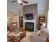 Comfortable living area with a fireplace, large windows, and stylish decor, creating an inviting atmosphere at 2771 Middlecreek Way, Cumming, GA 30041