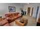 Inviting living room featuring leather sofa, coffee table, and exercise equipment near the bathroom at 2771 Middlecreek Way, Cumming, GA 30041
