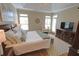 Bright bedroom featuring hardwood floors, a sitting area, and access to a private outdoor space at 2771 Middlecreek Way, Cumming, GA 30041