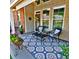 Inviting covered patio with cozy seating, decorative rug, and potted flowers, ideal for relaxation at 2771 Middlecreek Way, Cumming, GA 30041