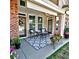 Charming covered patio with cozy seating, decorative rug, and manicured landscaping for relaxation at 2771 Middlecreek Way, Cumming, GA 30041