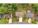 An aerial view showing the house nestled among mature trees, highlighted by lush landscaping at 387 Rose Creek Pl, Woodstock, GA 30189