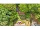 Aerial view of a beautifully maintained yard with patio area and mature trees at 387 Rose Creek Pl, Woodstock, GA 30189