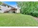 Expansive backyard featuring a deck with stairs to a patio area and a lush green lawn at 387 Rose Creek Pl, Woodstock, GA 30189