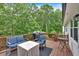 A lovely deck featuring patio furniture and a barbeque grill overlooking a serene, wooded backyard at 387 Rose Creek Pl, Woodstock, GA 30189