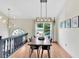 Stylish dining area featuring modern lighting and ample seating space at 387 Rose Creek Pl, Woodstock, GA 30189
