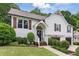 Charming two-story home featuring a welcoming front porch, well-manicured lawn, and a two-car garage at 387 Rose Creek Pl, Woodstock, GA 30189