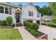 Charming two-story home featuring a welcoming front porch, well-manicured lawn, and a two-car garage at 387 Rose Creek Pl, Woodstock, GA 30189