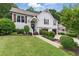 Charming two-story home featuring a welcoming front porch, well-manicured lawn, and a two-car garage at 387 Rose Creek Pl, Woodstock, GA 30189