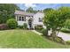 Beautiful two-story home with a green lawn, attractive landscaping, and a two-car garage at 387 Rose Creek Pl, Woodstock, GA 30189