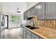 Contemporary kitchen featuring granite countertops, modern appliances, and a view at 387 Rose Creek Pl, Woodstock, GA 30189