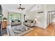 Bright living room with a fireplace, a ceiling fan, and natural light at 387 Rose Creek Pl, Woodstock, GA 30189