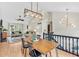 Sunlit living area boasts hardwood floors and elegant lighting fixtures at 387 Rose Creek Pl, Woodstock, GA 30189