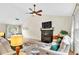 Open concept with a fireplace, a ceiling fan, and natural light at 387 Rose Creek Pl, Woodstock, GA 30189