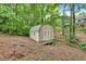 Backyard shed featuring double doors, siding, and stairs up to the door at 387 Rose Creek Pl, Woodstock, GA 30189