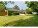 Expansive backyard featuring lush green lawn, privacy fence, a storage shed, and a patio area for outdoor entertaining at 690 Glenforest Rd, Sandy Springs, GA 30328