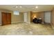 Spacious basement area with a unique stone tile floor, storage cabinet, and a cozy work space at 690 Glenforest Rd, Sandy Springs, GA 30328