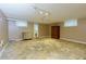 Unfinished basement featuring a unique stone-look floor, neutral walls, and natural light from windows at 690 Glenforest Rd, Sandy Springs, GA 30328