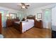 Bedroom featuring hardwood floors, neutral wall paint, a ceiling fan, and two windows at 690 Glenforest Rd, Sandy Springs, GA 30328