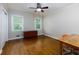 Bedroom featuring hardwood floors, neutral wall paint, a ceiling fan, and two windows at 690 Glenforest Rd, Sandy Springs, GA 30328