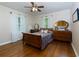 Bedroom featuring hardwood floors, a ceiling fan, neutral wall paint, and antique wooden furniture at 690 Glenforest Rd, Sandy Springs, GA 30328