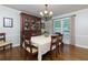 Formal dining room with wood floors, a chandelier, a wooden china cabinet, and natural light at 690 Glenforest Rd, Sandy Springs, GA 30328