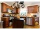 Kitchen with stainless steel appliances, granite countertops, dark brown cabinets, and hardwood floors at 690 Glenforest Rd, Sandy Springs, GA 30328