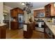 Kitchen featuring stainless steel appliances, granite countertops, dark brown cabinets, and hardwood floors at 690 Glenforest Rd, Sandy Springs, GA 30328