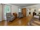 Spacious living room featuring hardwood floors, two chairs, a couch, and large windows for ample natural light at 690 Glenforest Rd, Sandy Springs, GA 30328