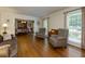 Bright living room with hardwood floors, neutral walls, and an open view to the formal dining room at 690 Glenforest Rd, Sandy Springs, GA 30328