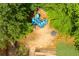 A blue playground with slides and climbing structures surrounded by lush greenery at 690 Glenforest Rd, Sandy Springs, GA 30328
