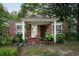 Charming brick home with a cozy front porch and abundant greenery at 1336 Sharon St, Atlanta, GA 30314