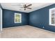 Serene bedroom with plush carpeting, two bright windows and contemporary ceiling fan at 2917 Rockbridge Rd, Marietta, GA 30066