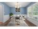 Elegant dining room with modern lighting, wainscoting, and large window at 2917 Rockbridge Rd, Marietta, GA 30066