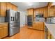 Bright kitchen featuring stainless steel appliances, wooden cabinets, and durable hardwood floors at 2917 Rockbridge Rd, Marietta, GA 30066