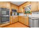 Well-equipped kitchen with stainless steel appliances, wooden cabinets, and wood flooring at 2917 Rockbridge Rd, Marietta, GA 30066