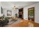 Cozy living room features a brick fireplace, wood floors, and ample natural light at 2917 Rockbridge Rd, Marietta, GA 30066