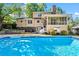Stunning backyard features a large in-ground pool, screened in porch, and well-manicured landscaping at 2917 Rockbridge Rd, Marietta, GA 30066