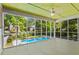 Relaxing screened porch showcases beautiful views of the private pool and backyard at 2917 Rockbridge Rd, Marietta, GA 30066