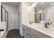Primary bathroom showcasing a dual sink vanity, framed mirrors and a glass enclosed shower at 3564 Arrow Root Cir, Loganville, GA 30052