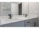 Bathroom featuring dual sinks, framed mirrors, neutral paint, and modern hardware at 3564 Arrow Root Cir, Loganville, GA 30052