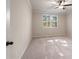 Spacious bedroom with carpet, neutral paint, ceiling fan and window with wooded view at 3564 Arrow Root Cir, Loganville, GA 30052