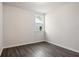 Modern bedroom featuring hardwood flooring, a window, and white walls at 3564 Arrow Root Cir, Loganville, GA 30052