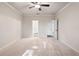 Large primary bedroom featuring plush carpet, neutral paint, ceiling fan and ensuite bathroom access at 3564 Arrow Root Cir, Loganville, GA 30052