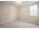 Neutral bedroom featuring plush carpet, a single window, and white walls at 3564 Arrow Root Cir, Loganville, GA 30052