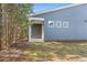 The exterior features three windows, covered entryway and gray siding at 3564 Arrow Root Cir, Loganville, GA 30052