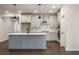 Stylish kitchen featuring white cabinets, stainless appliances, and a central island with dark accents at 3564 Arrow Root Cir, Loganville, GA 30052